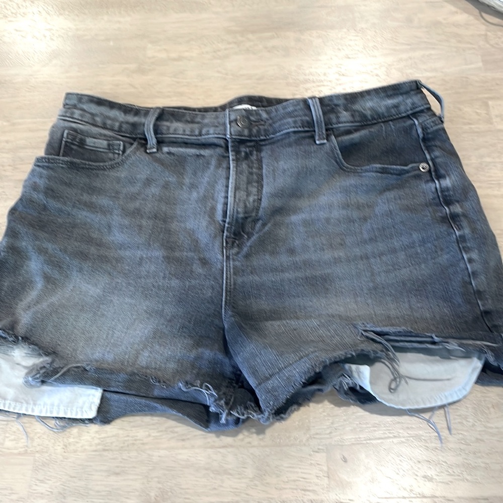 High rise distressed black denim short shorts with revealing pockets